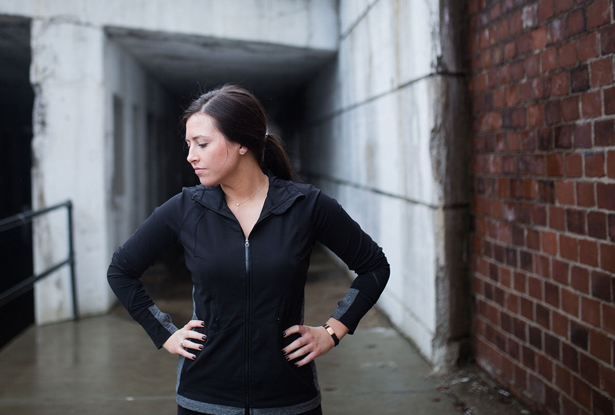 Female runner catching her breath wearing the rose gold ROAD iD