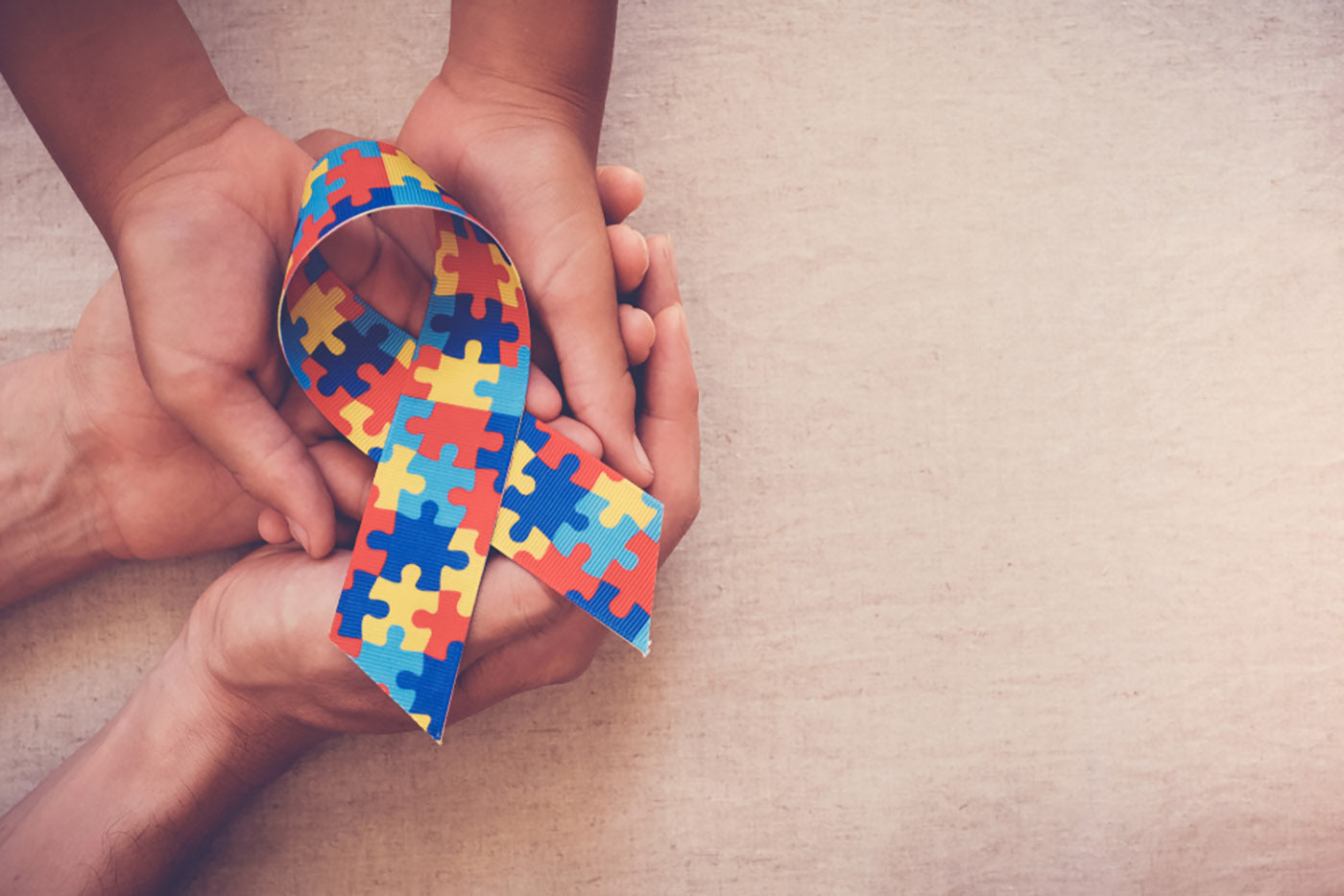 hands holding puzzle ribbon