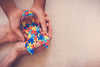 hands holding puzzle ribbon