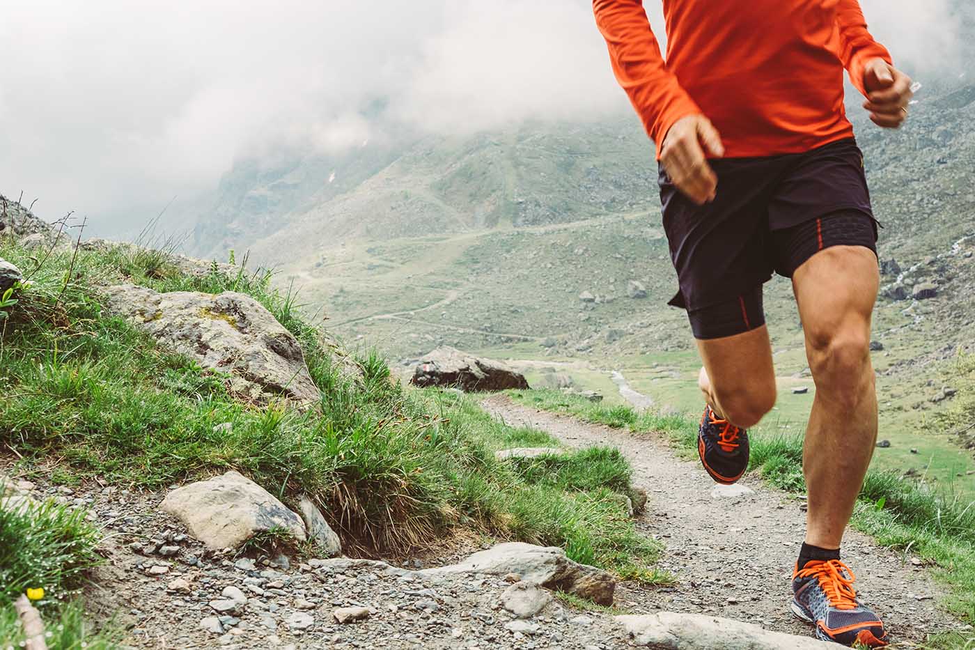 a man running on a mountain trail