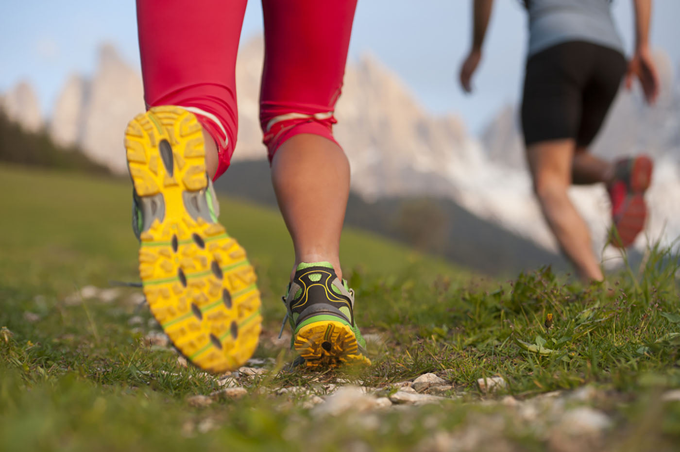 two people running up a mountainside