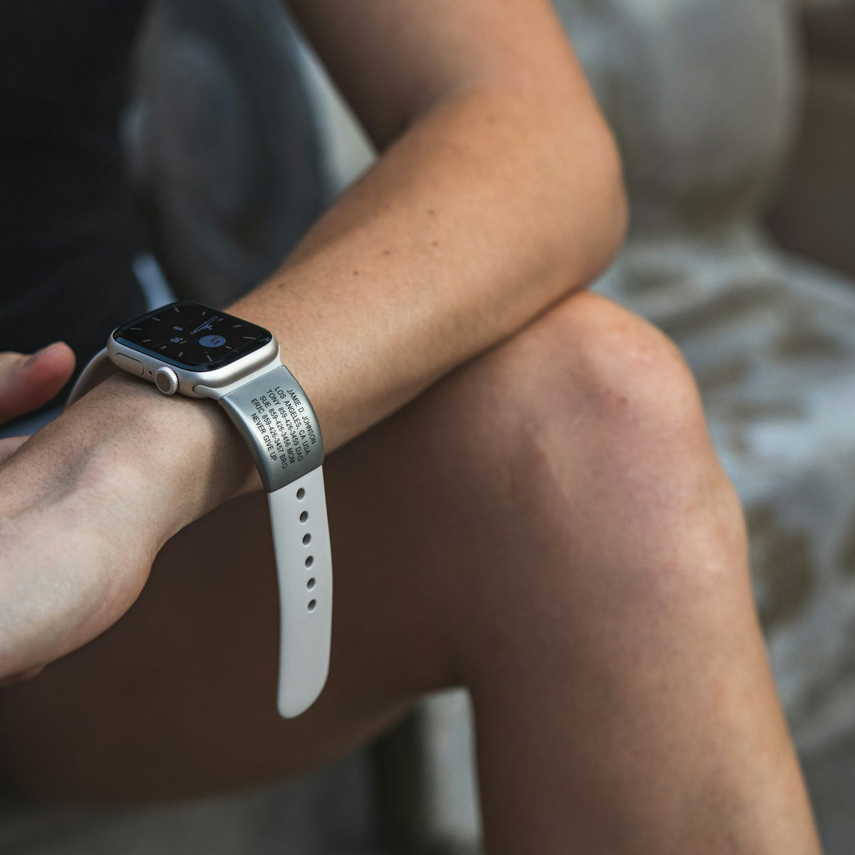 Close up of runner sitting down adjusting their ROADiD Apple Watch engraved ID.