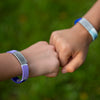 Kids fist bumping wearing their super cool Stretch ID for Kids!